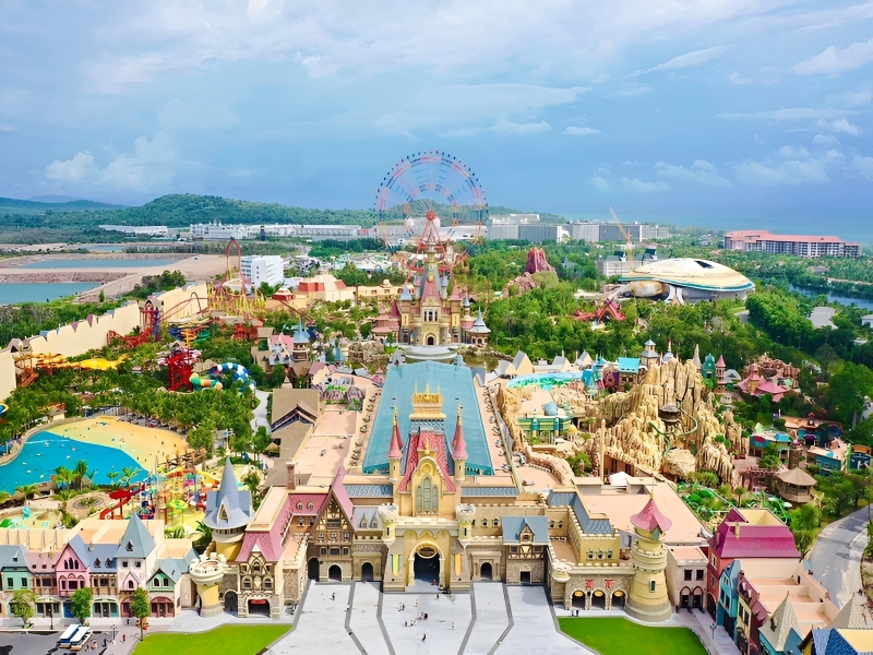 A professional aerial view of VinWonders theme park and Grand World complex showcasing the massive entertainment scale near Corona Casino Phu Quoc