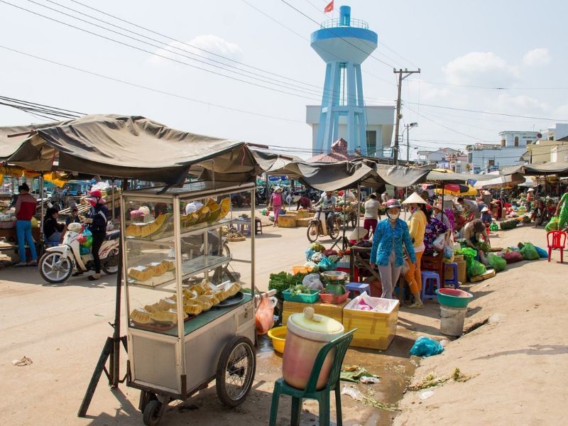 Vendors prepare fresh catch and herbs near the bustling An Thoi Port