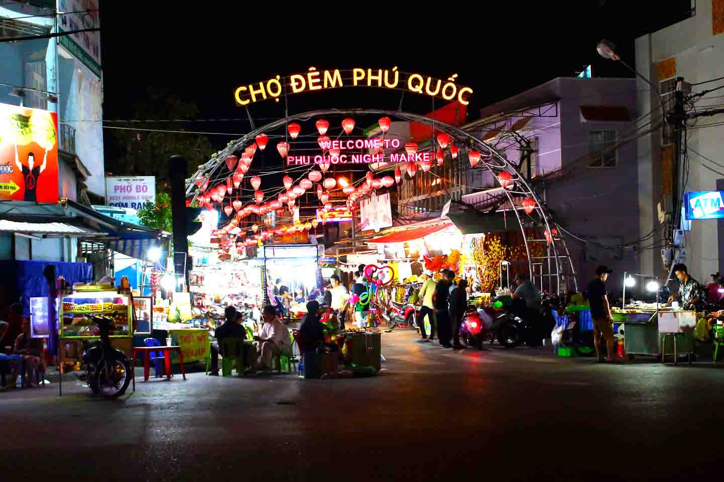 Tourists explore the bustling Phu Quoc Night Market, filled with local seafood stalls, souvenirs, and glowing lanterns Corona Casino Phu Quoc