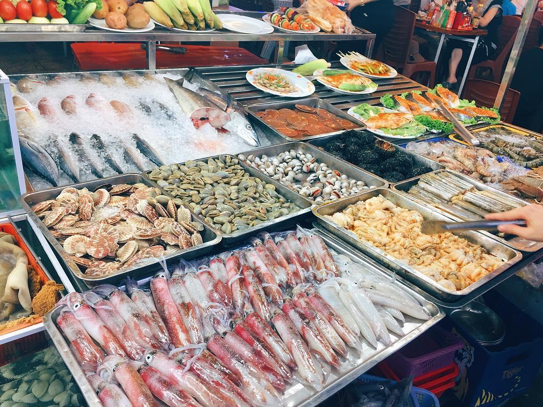 Tourists selecting freshly caught seafood at morning stalls Corona Casino Phu Quoc