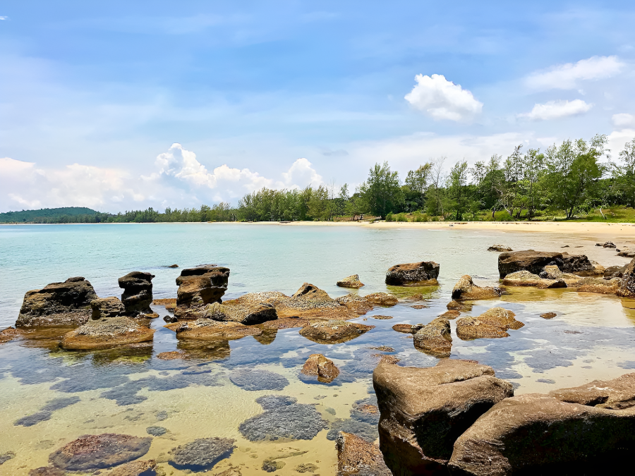 Vacationers relaxing at Vung Bau Beach Phu Quoc in the perfect travel season near Corona Casino Phu Quoc