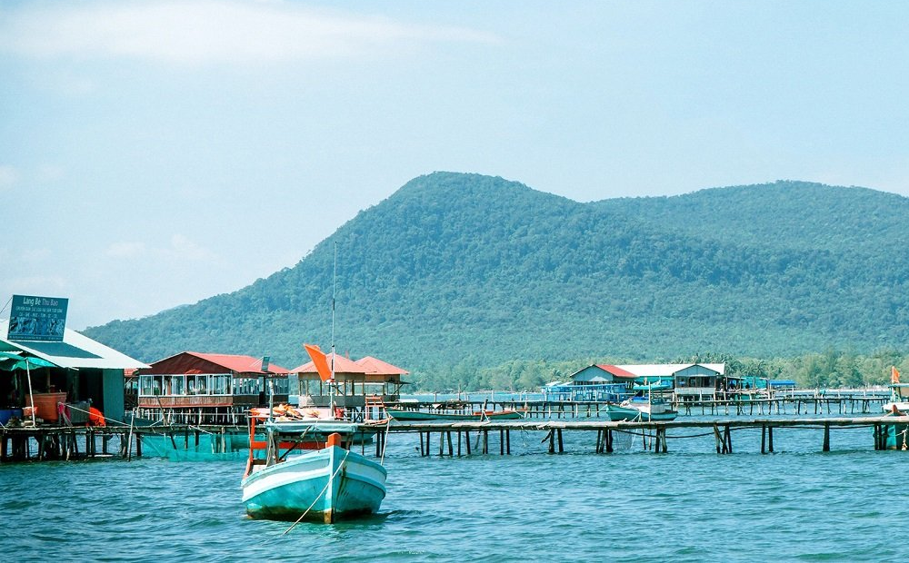 Tourists observing red starfish in the shallow waters of Rach Vem The starfish beach experience near Corona Casino Phu Quoc