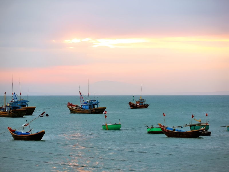 A serene view of Ham Ninh fishing boats at sunrise capturing the authentic local life near Corona Casino Phu Quoc