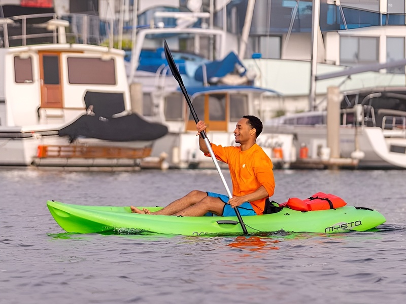A price board showing kayak rental costs and hourly rates for water sports near Corona Casino Phu Quoc