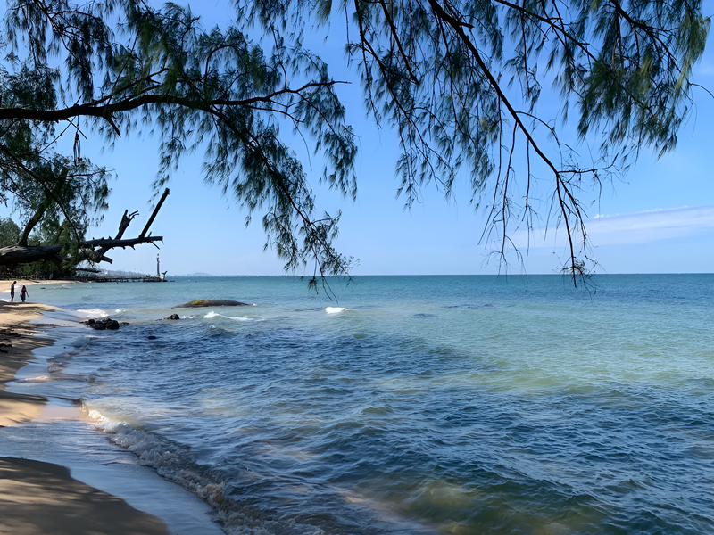 Enjoying the serenity and calm waves on the empty beach ideal for beginning surfing at Ong Lang Beach Phu Quoc far from Corona Casino Phu Quoc