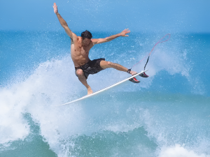 A surfer successfully riding the island's best waves experiencing Surfing in Phu Quoc near Corona Casino Phu Quoc