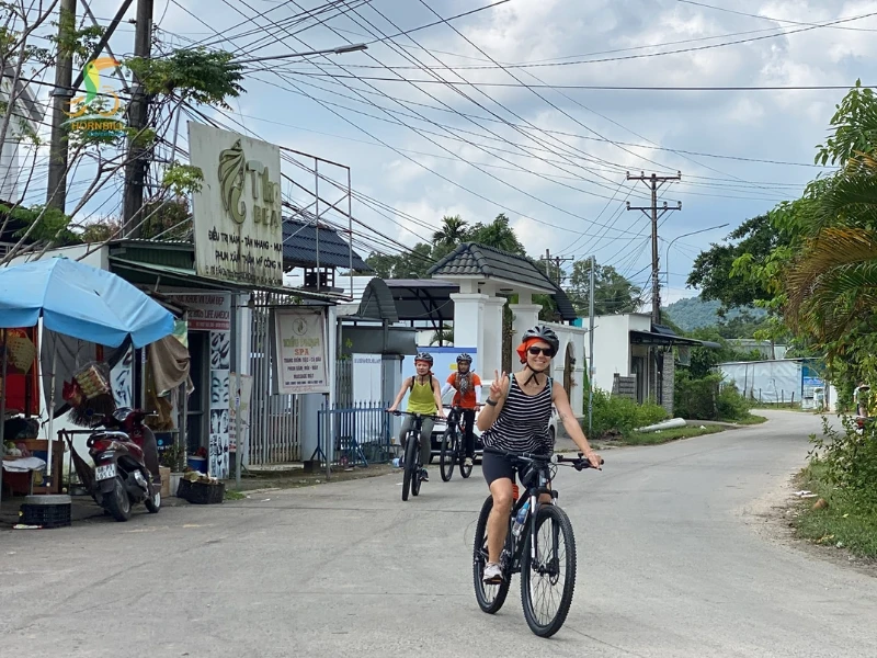 Travelers enjoying a peaceful coastal ride through villages and hidden beaches close to the Corona Casino Phu Quoc complex