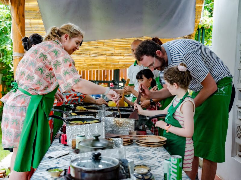 Travelers enjoying a hands-on culinary experience at Troc’s Kitchen & Cooking Class close to the Corona Casino Phu Quoc complex