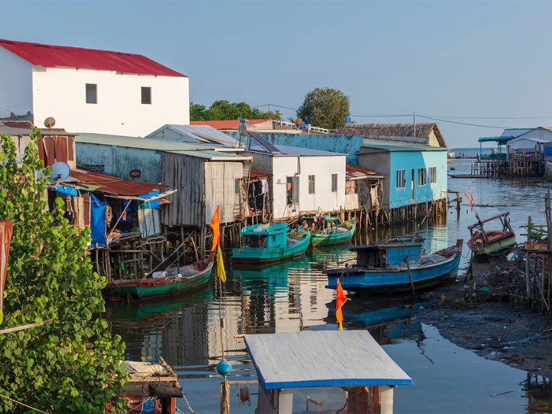 Travelers exploring the local seafood market at Ham Ninh Fishing Village during their vacation at the luxury Corona Casino Phu Quoc resort