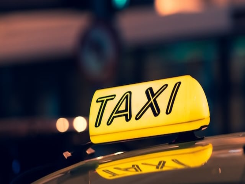 A professional photo showing an Overview of Taxi Services on the Pearl Island parked outside the luxury Corona Casino Phu Quoc resort