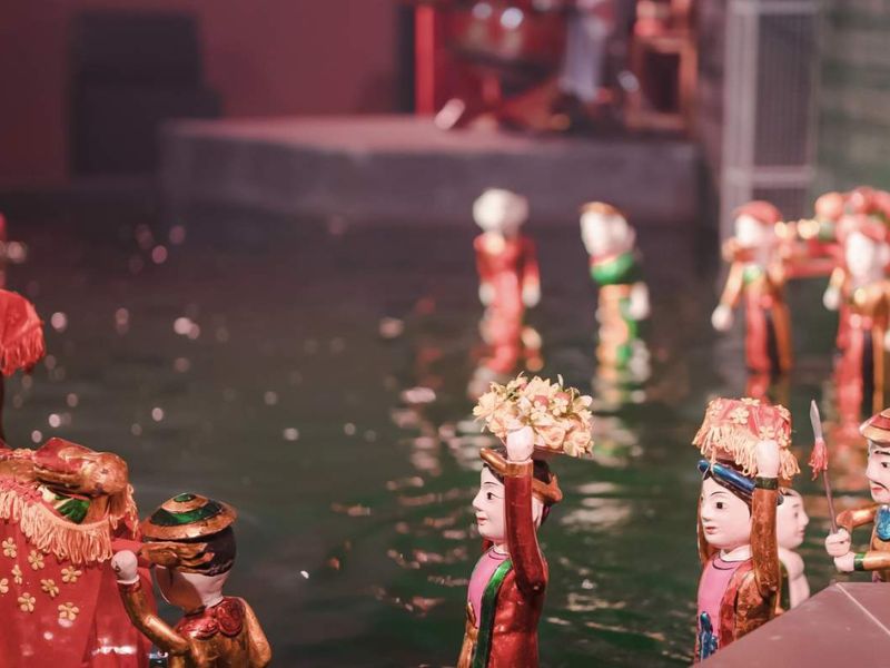 A professional photo showing how water puppetry is a unique Vietnamese folk art that originated in the Red River Delta now performed near the luxury Corona Casino Phu Quoc resort