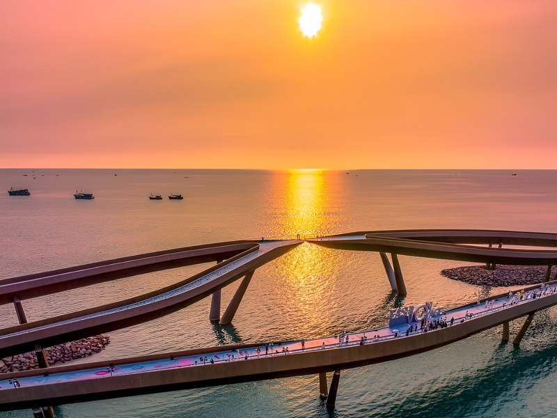 A professional landscape of a Golden sunset over the crystal waters of Phu Quoc island visible for guests at the luxury Corona Casino Phu Quoc