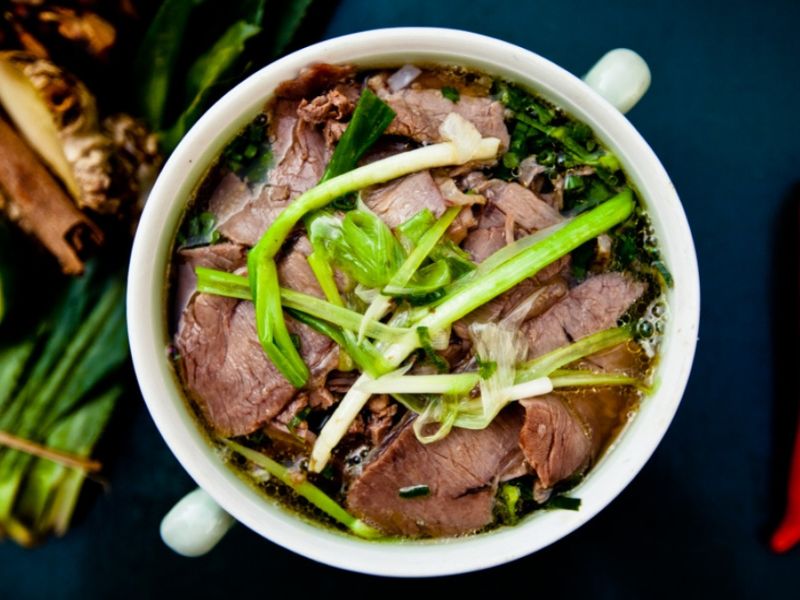 International tourists enjoying a Traditional Pho Vietnamese noodle soup breakfast before a day of excitement at the famous Corona Casino Phu Quoc