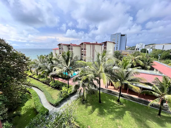 A professional landscape of the Dusit Princess infinity pool at sunset on West coast highlighting the premium lifestyle at Corona Casino Phu Quoc