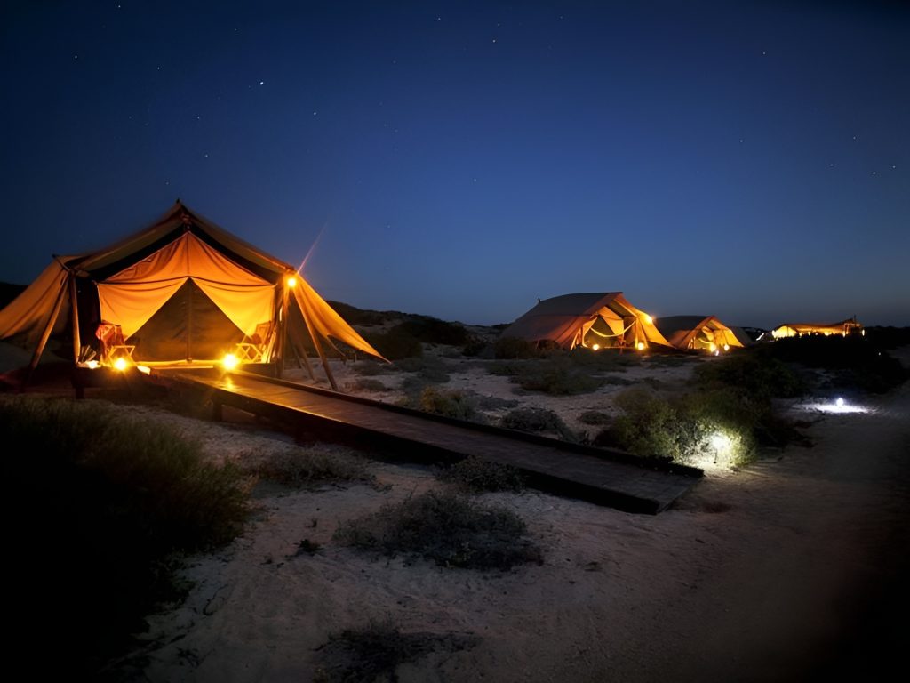 A stunning evening scene featuring a beautiful sunset and overnight camping on May Rut beach for guests of the world-class Corona Casino Phu Quoc