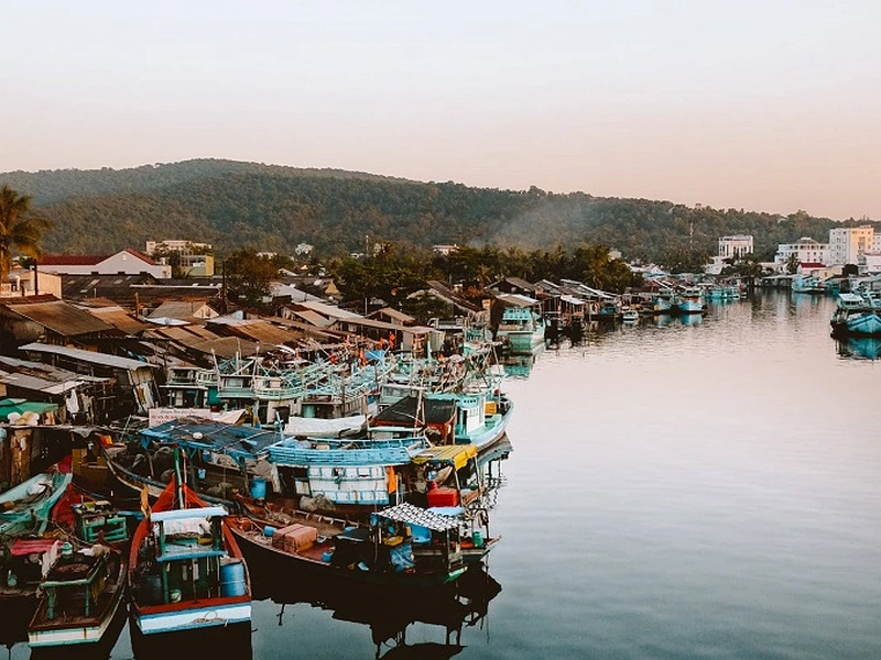 Densely packed fishing boats moored along a riverbank in Phu Quoc near Corona Resort & Casino Phu Quoc