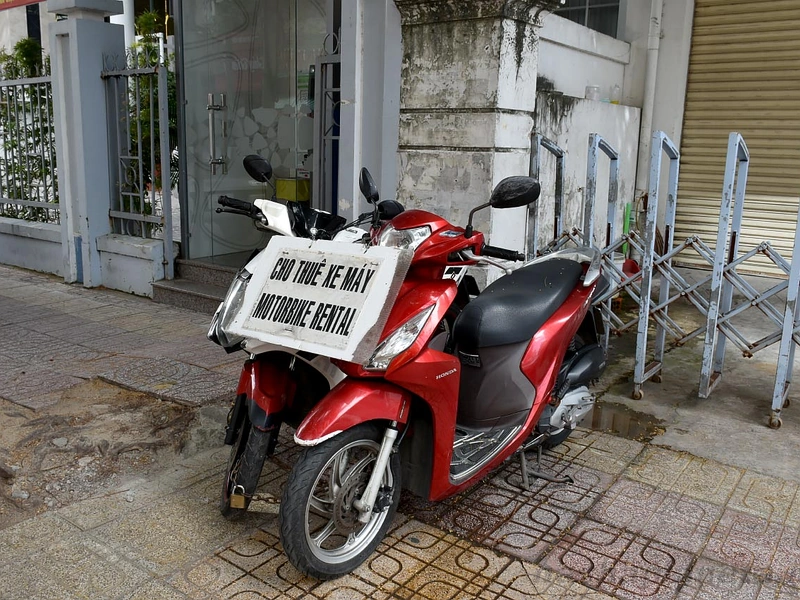 Scooters parked on the street with a Motorbike Rental sign near Corona Resort & Casino Phu Quoc