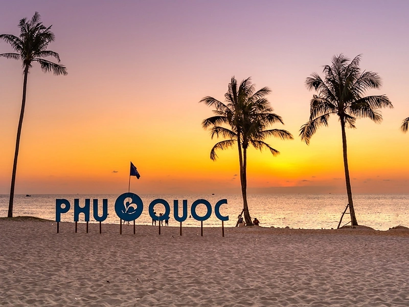Sunset silhouette on beach with giant Phu Quoc letters near Corona Resort & Casino Phu Quoc