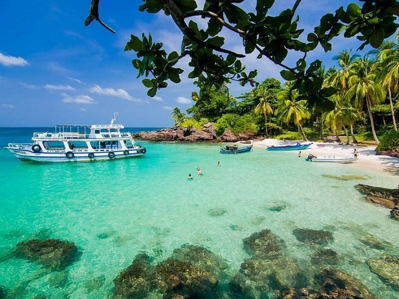 Tourist boats anchored in clear turquoise water of An Thoi Archipelago near Corona Resort & Casino Phu Quoc