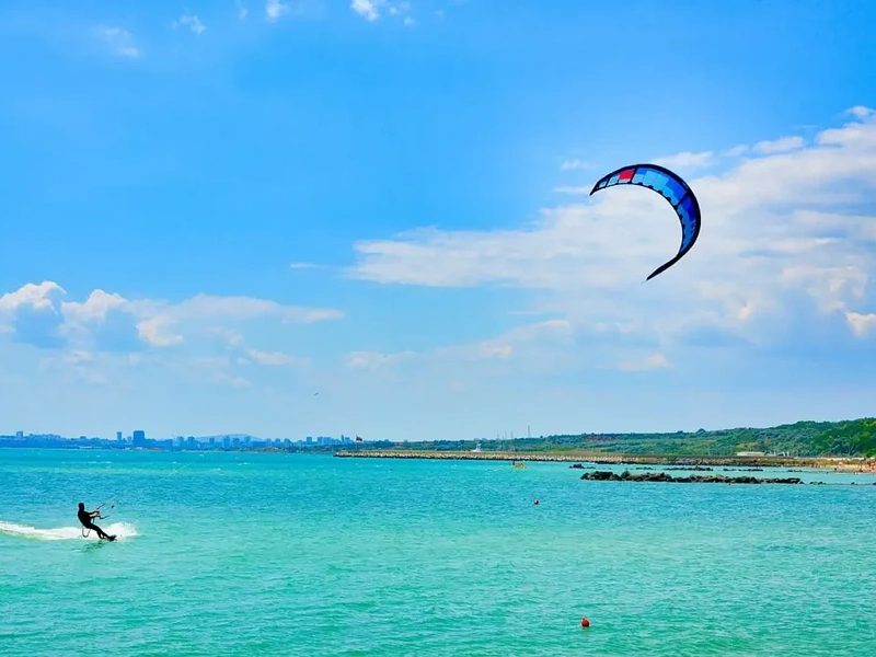 Wide angle view of a kitesurfer and a colorful kite in the sky near Corona Resort & Casino Phu Quoc