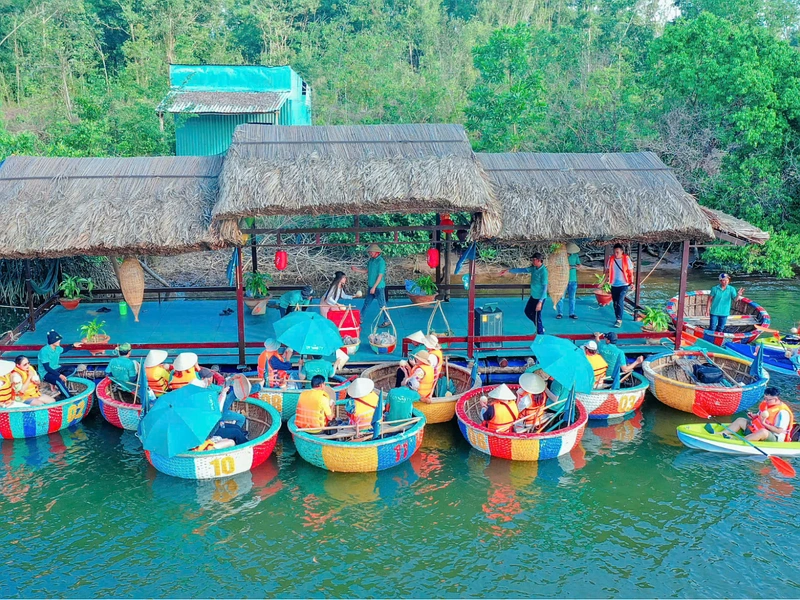 Tourists taking a basket boat river tour through the Cua Can mangroves in Phu Quoc